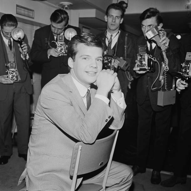 American pop singer Bobby Vee surrounded by photographers, UK, 24th February 1964.