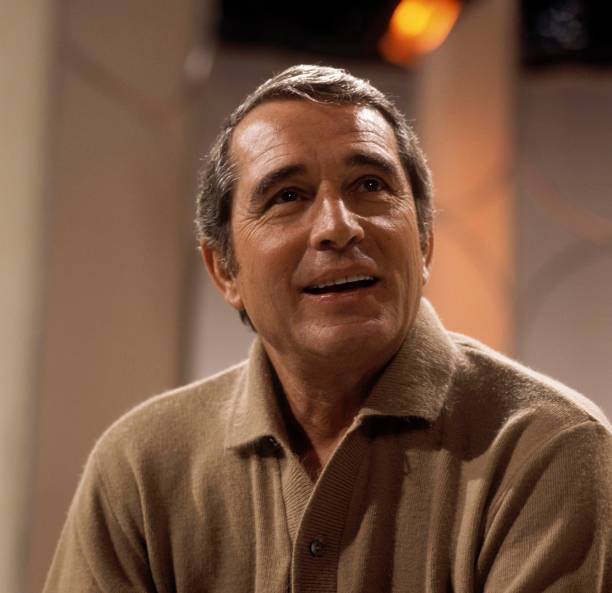 American singer and actor Perry Como posed on a television show in London circa 1970.