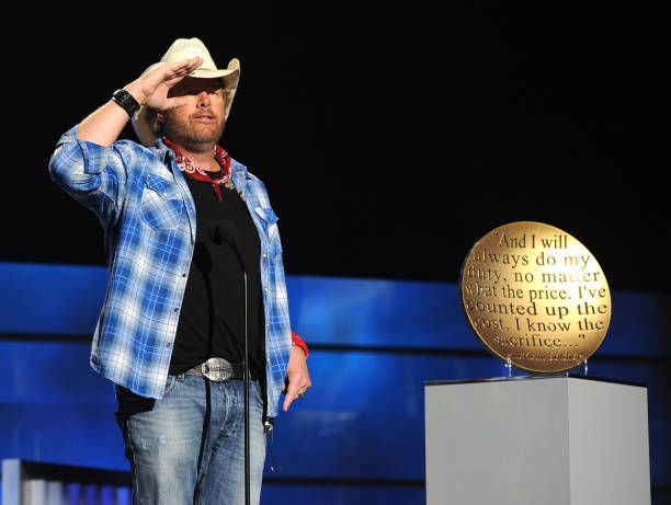 Musician Toby Keith accepts USO award onstage during ACM Presents: An All-Star Salute To The Troops at the MGM Grand Garden Arena on April 7, 2014 in...