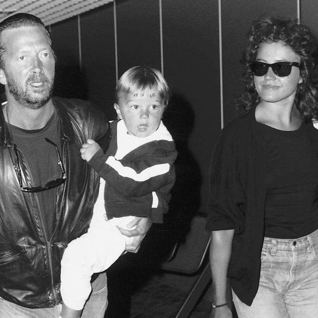 Eric Clapton singer songwriter and girlfriend Lori Del Santo walk through airport with son Conor